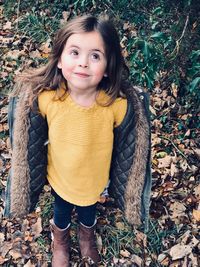 High angle view of girl wearing warm clothing on field