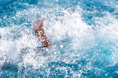 Man jumping in swimming pool