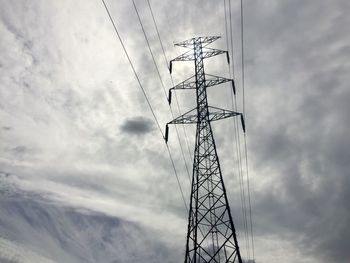 Low angle view of electricity pylon against sky