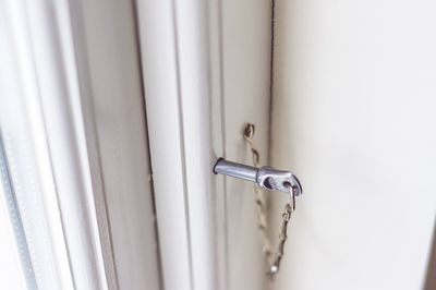 Close-up of key in locked door