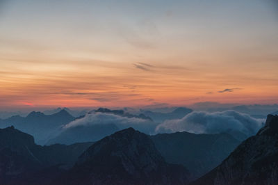 Scenic view of silhouette mountains against sky during sunset