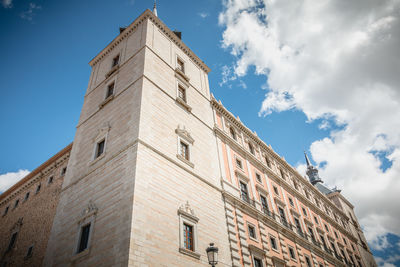 Low angle view of building against cloudy sky