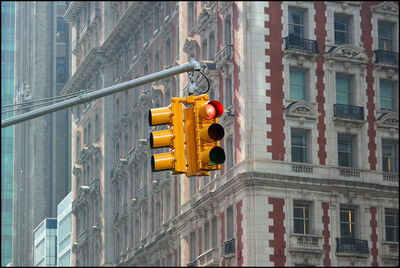Low angle view of stoplight against building