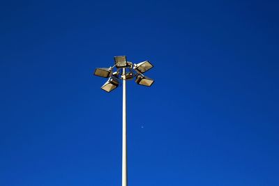 Low angle view of street light against blue sky