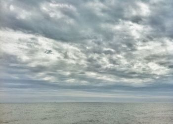 Scenic view of sea against cloudy sky