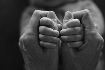 Close-up of hands holding baby hand