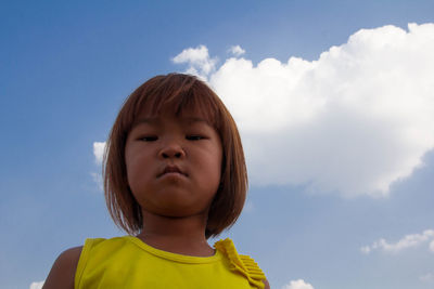 Portrait of girl against sky