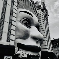 Low angle view of statue against building in city