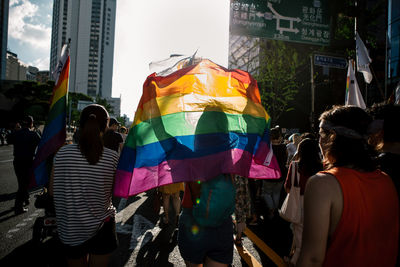 Rear view of people walking on street