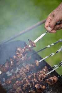 Cropped hand of man preparing food