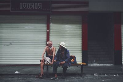 Full length of men standing by shutter