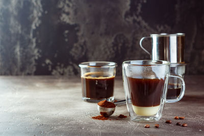 Close-up of coffee and glass on table