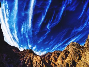 Panoramic view of mountains against blue sky