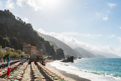 Scenic view of sea and mountains against sky