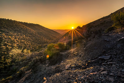 Sun shining over mountains