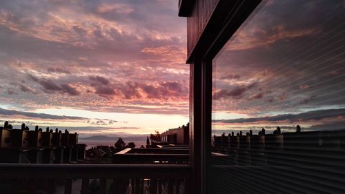 Silhouette of bridge against cloudy sky at sunset