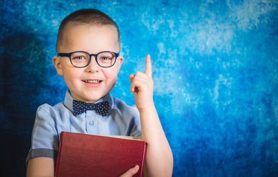 Portrait of smiling boy with book