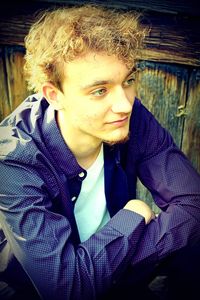 Portrait of young man sitting outdoors