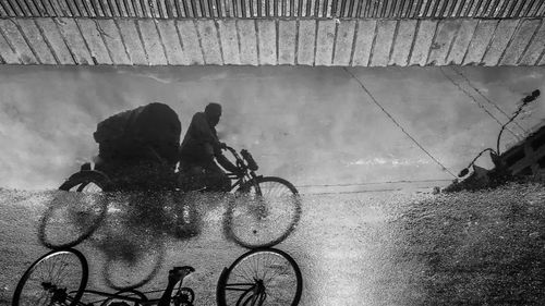 High angle view of people riding bicycle in city