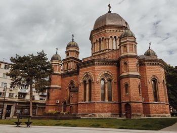 Low angle view of building against cloudy sky