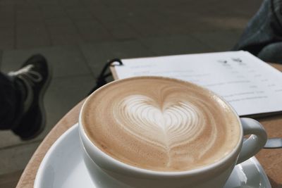 Close-up of cappuccino served on table