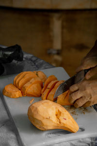 Cropped image of person preparing food on table