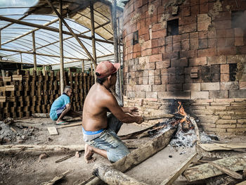 Rear view of men working in building