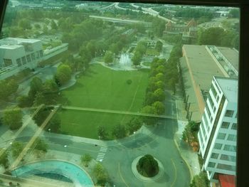 High angle view of swimming pool by buildings in city