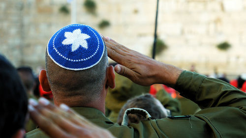 Rear view of soldiers saluting