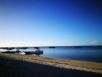 Boats moored at harbor