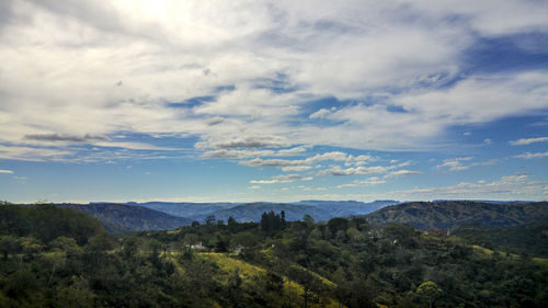 Scenic view of mountains against cloudy sky