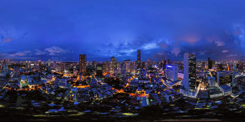 High angle view of illuminated city against sky at night