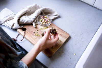 High angle view of person holding ice cream on table