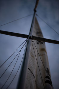 Low angle view of sailboat mast against sky