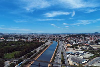 High angle view of road by buildings against sky