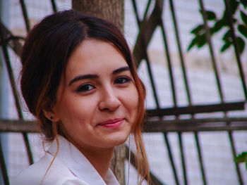 Close-up portrait of smiling young woman