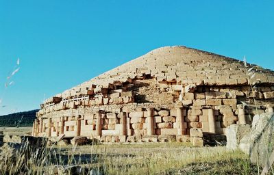 Old ruins of building against clear blue sky