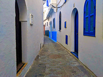 Empty alley amidst buildings in city