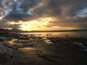 View of sea against cloudy sky during sunset