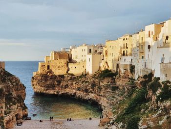 Panoramic view of the italian sea and white old buildings against sky