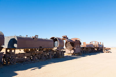 Train on desert against clear blue sky