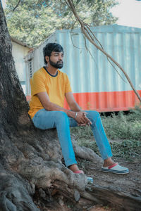 Young man sitting on rock