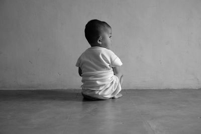 High angle view of boy standing against wall