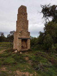 Old ruin on field against sky