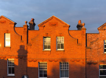 Sunlight on residential building against sky