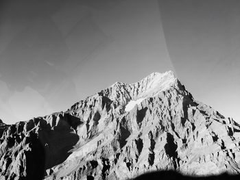 Low angle view of snowcapped mountain against sky