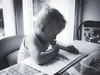 Boy playing with table at home