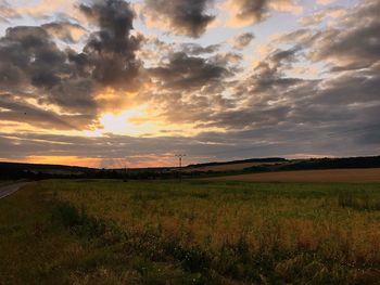 Scenic view of field against sky during sunset