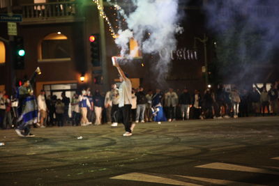 People on street in city at night