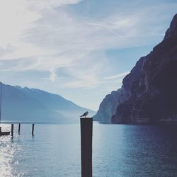 Scenic view of sea and mountains against sky